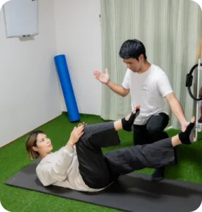 a man and woman exercising on a mat